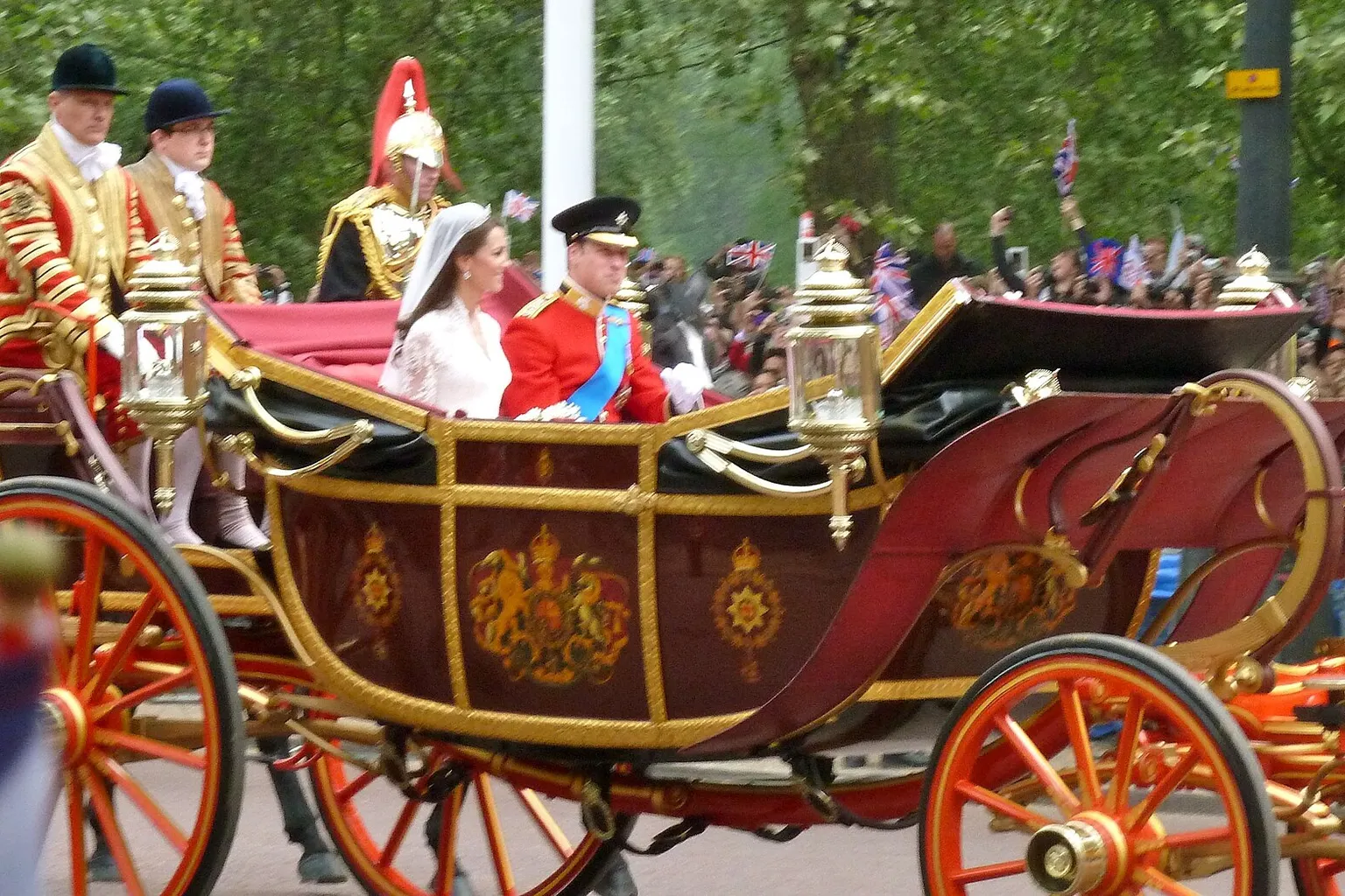 Le landau d'État de 1902 avec William et Catherine, vu de profil, roues rouges et dorées